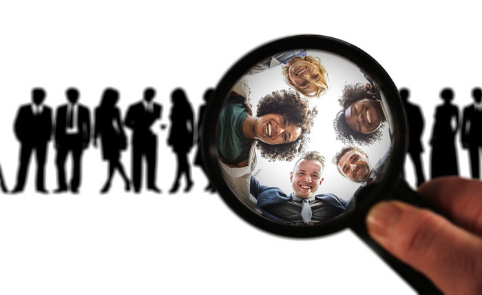 people looking through magnifying glass